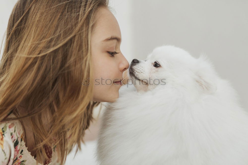 Similar – young woman with her dog at the park. she is kissing the dog. autumn season