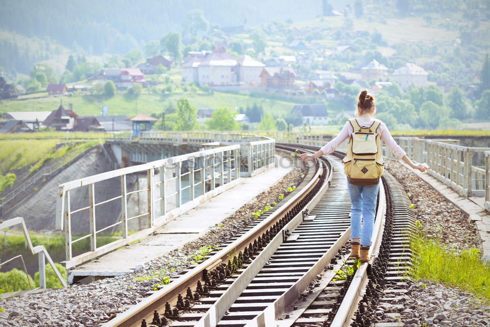 Similar – boy on the train tracks with suitcase