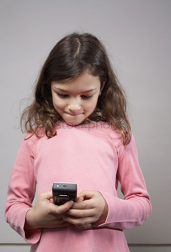 Similar – portrait of a beautiful kid using mobile phone