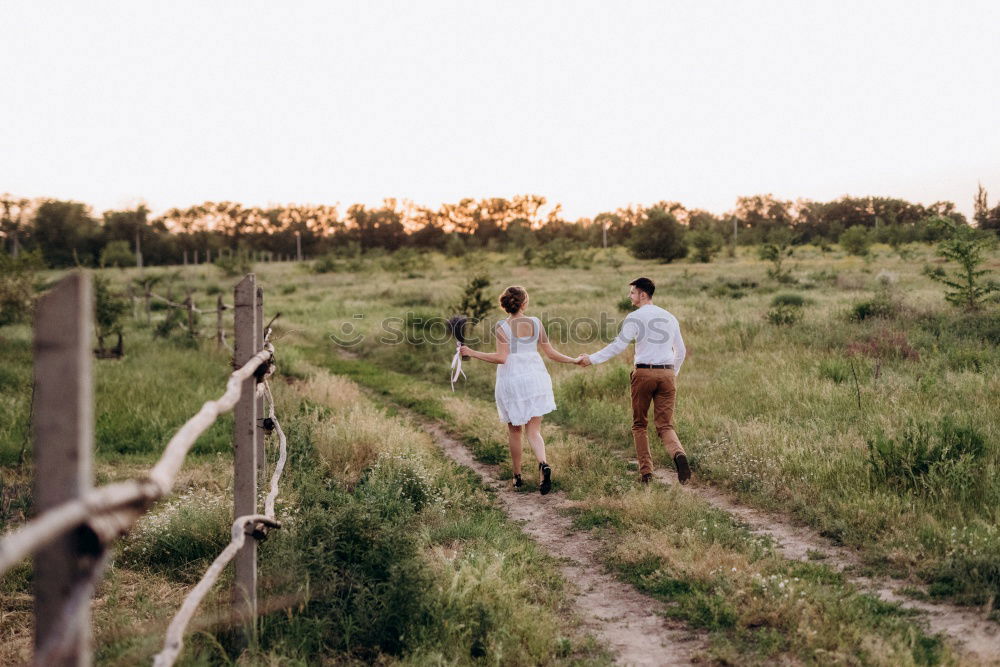 Similar – Couple of young people standing and held hands