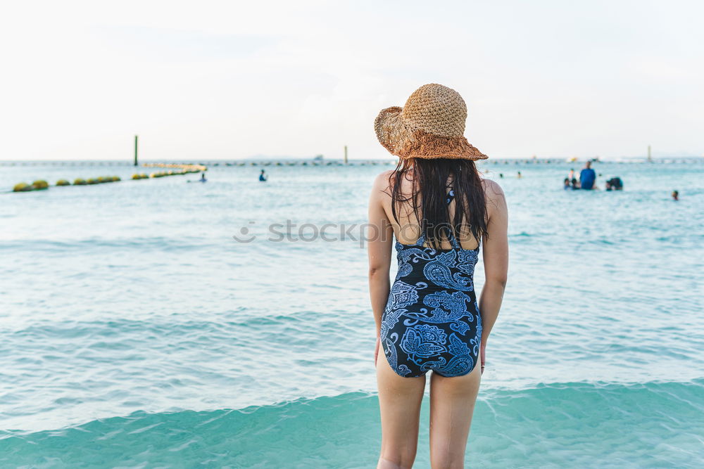 Similar – Asian woman standing on the terrace and looking around the sea.