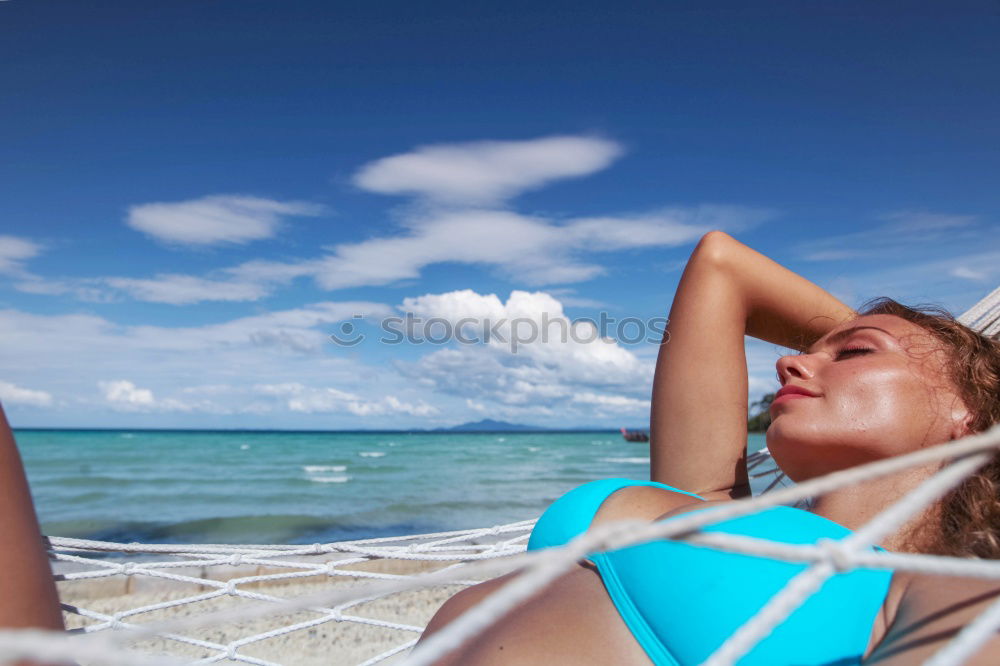 Similar – Woman in bikini sitting on bench near water