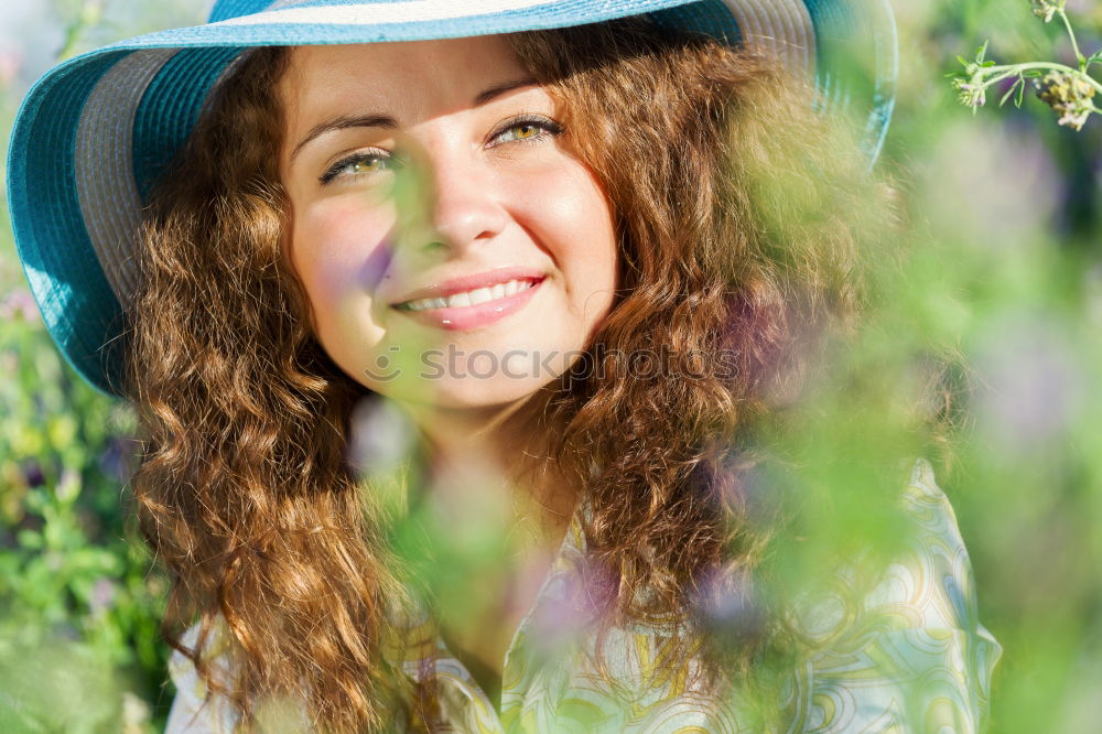 Similar – Young woman resting in a field of flowers