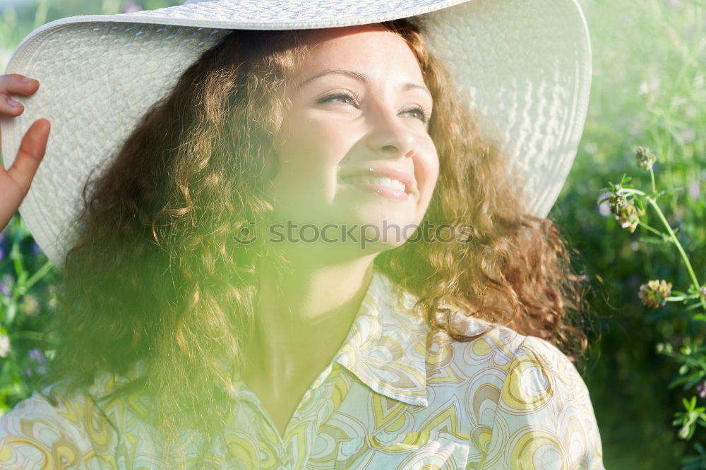 Similar – Young woman resting in a field of flowers