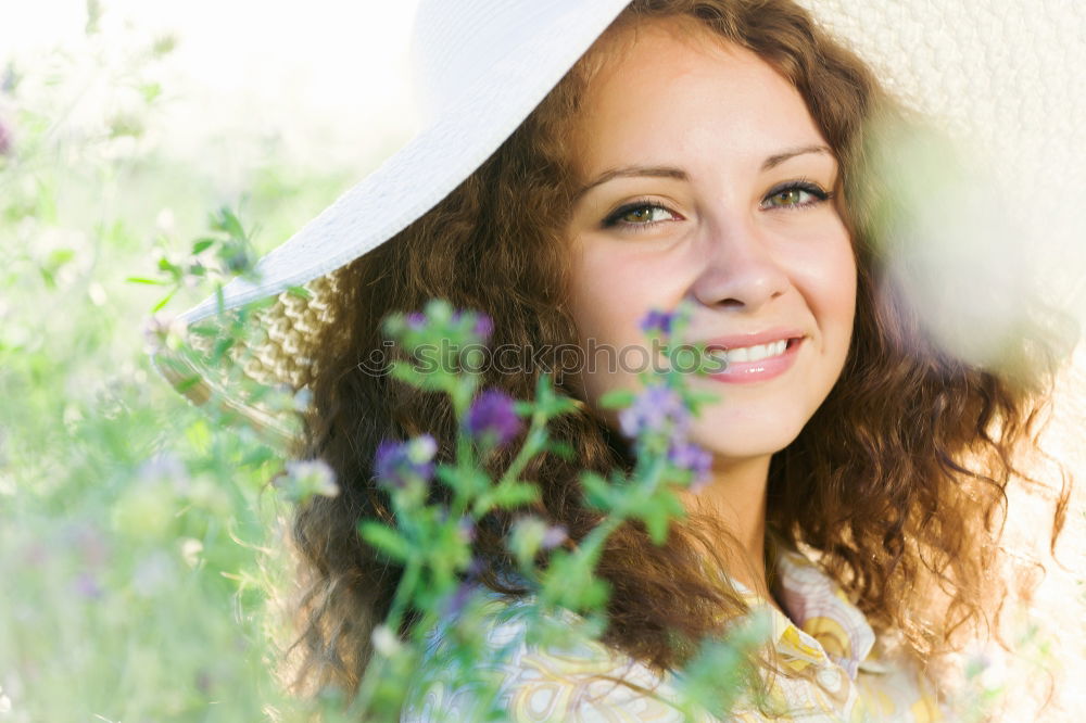 Similar – Young woman resting in a field of flowers