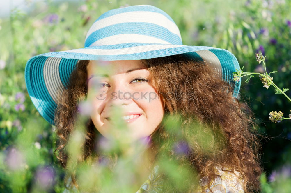 Similar – Young woman resting in a field of flowers