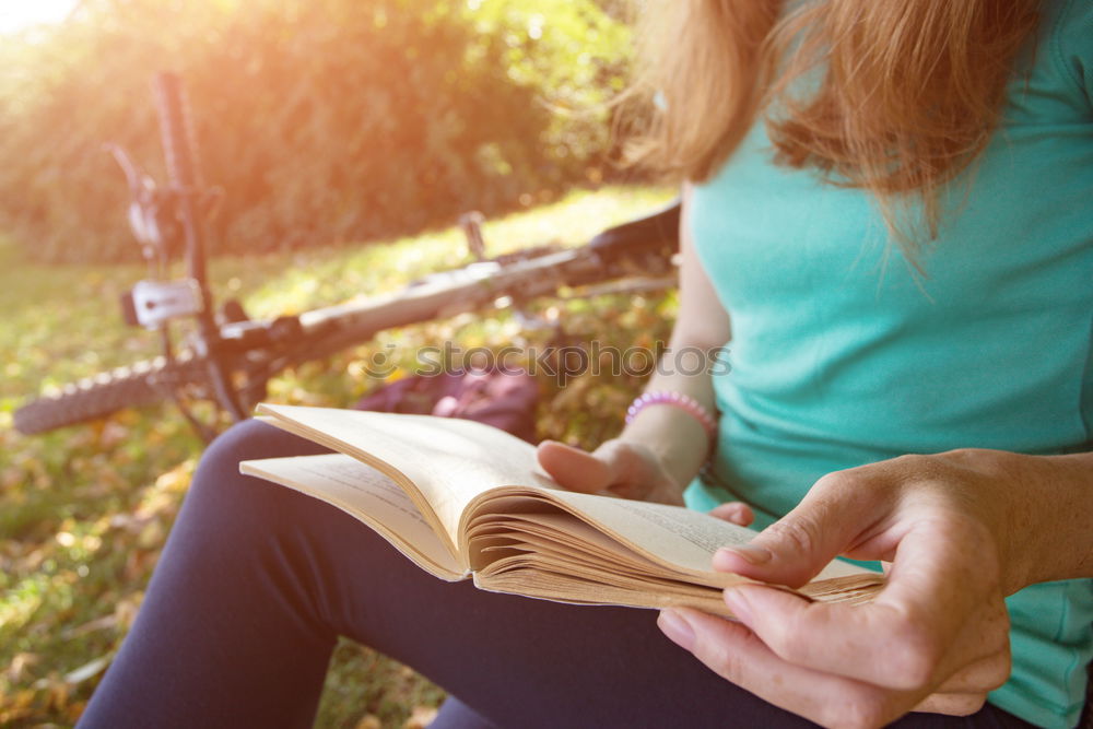 Similar – Woman reading a book outdoors