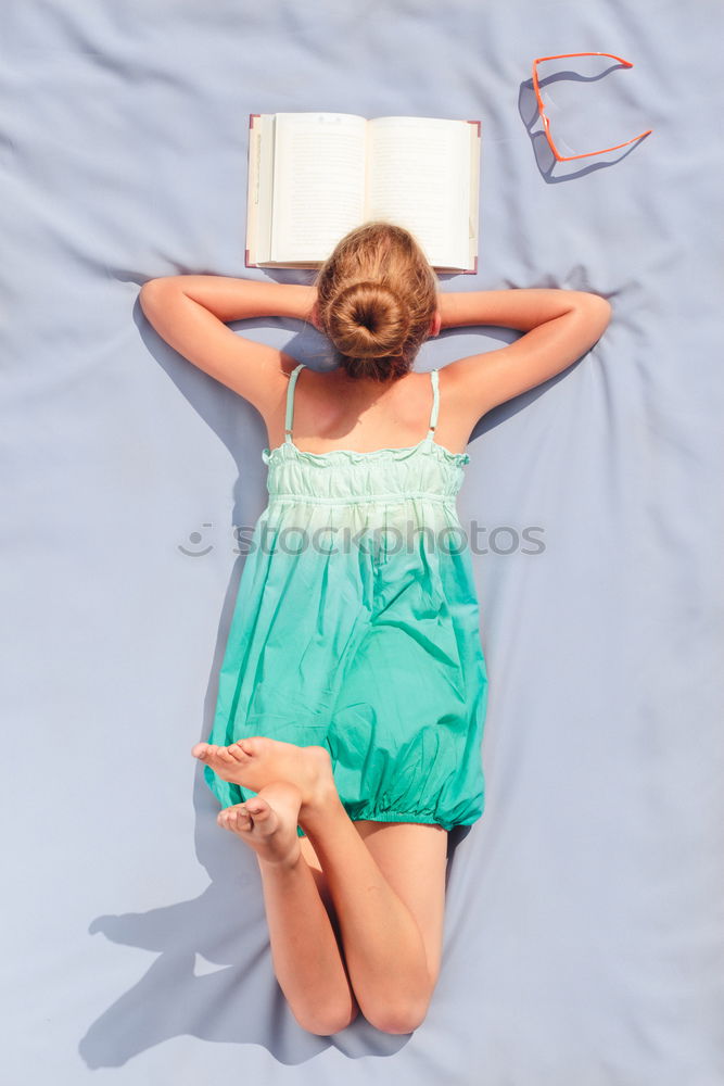 Image, Stock Photo Girl lying on a blanket and reading a book on a sunny day