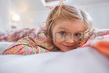 Similar – happy little child girl lying on her bed in the morning