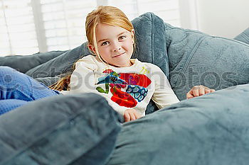 Similar – Image, Stock Photo Kids playing video game sitting on sofa at home