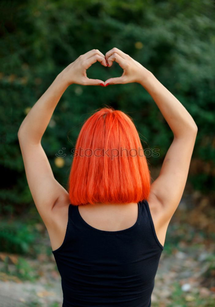 Girl making a heart shape symbol