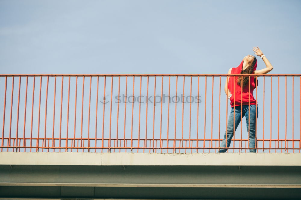 Young fitness woman runner running on city bridge.