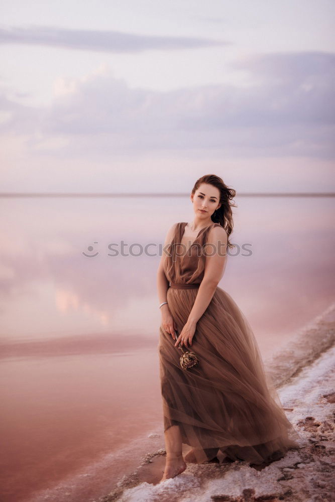 Pretty Asian woman sitting at pond