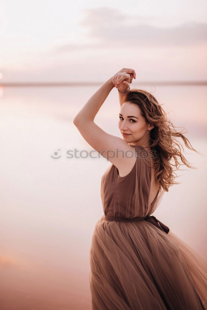 Similar – Image, Stock Photo Young Girl is sitting enjoying the view of the sunset at ocean