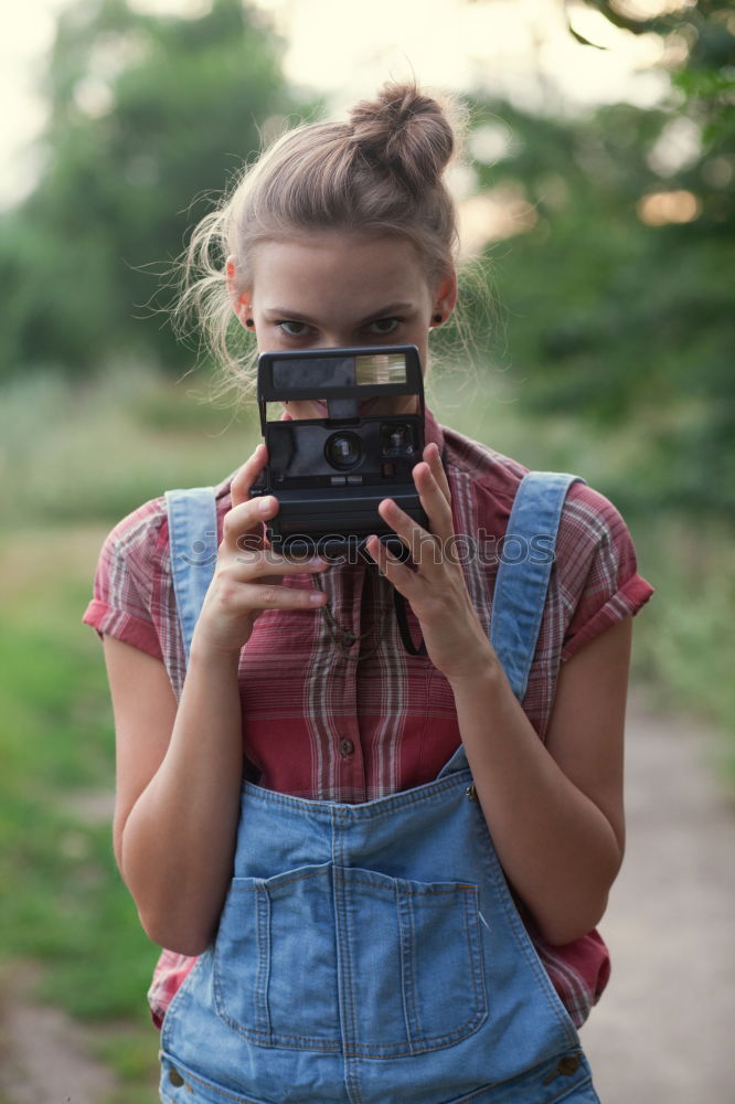 Similar – Young redhead woman taking shots with her analog camera