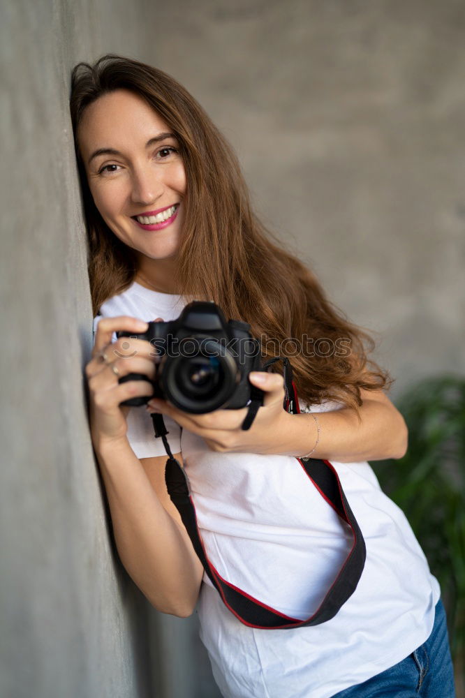 Similar – Cropped woman with vintage old camera