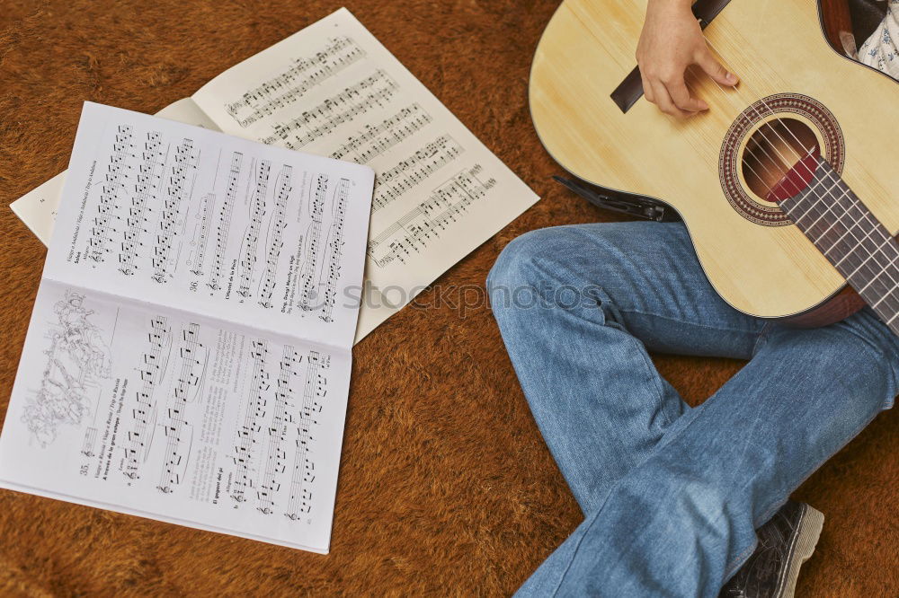 Similar – Image, Stock Photo Man playing guitar and composing music at home near a bright window on a sunny day. Casual musician sitting on the floor playing the guitar.