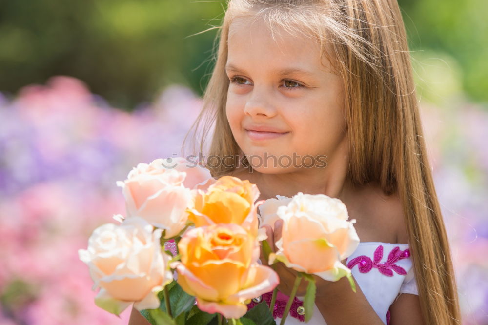 Similar – romantic portrait of happy child girl picking bouquet of beautiful blue delphinium flowers from summer garden