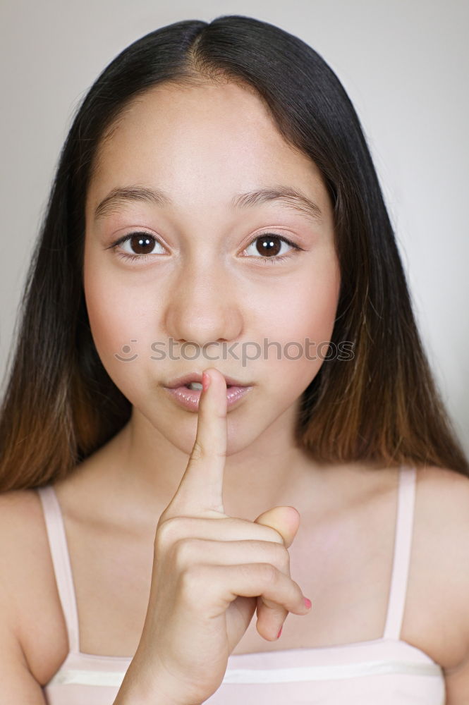 Similar – Young Girl Gesturing Silence.