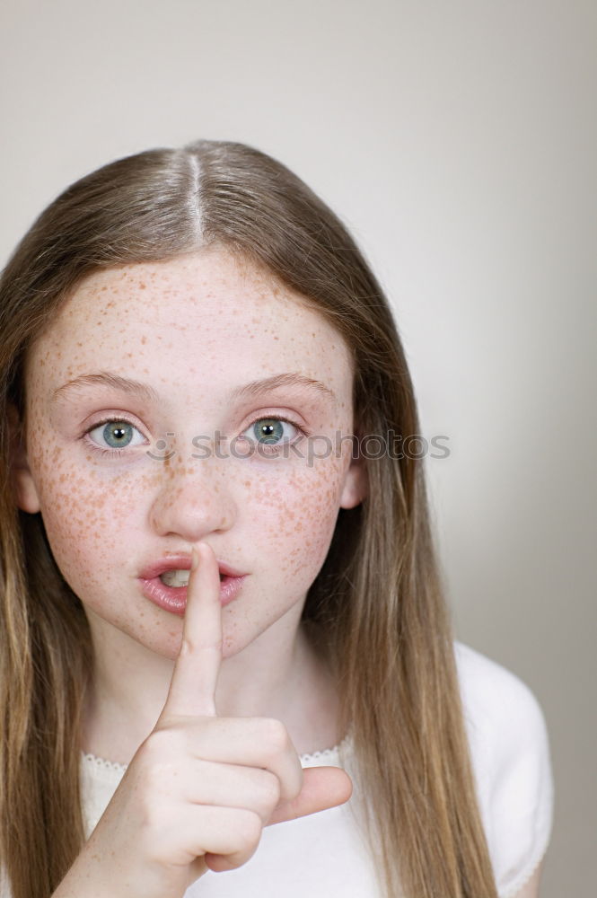 Similar – Young Girl Gesturing Silence.