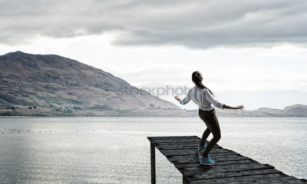 Similar – Image, Stock Photo Young adult in front of mountain dam