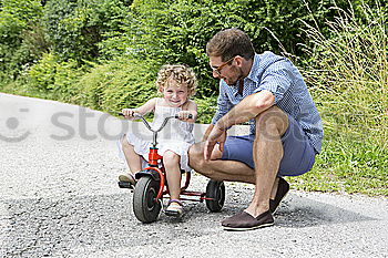 Father and daughter playing on the road at the day time.