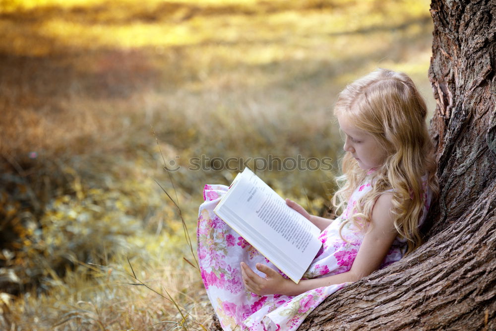 Similar – Image, Stock Photo Little baby girl watching a book with pictures