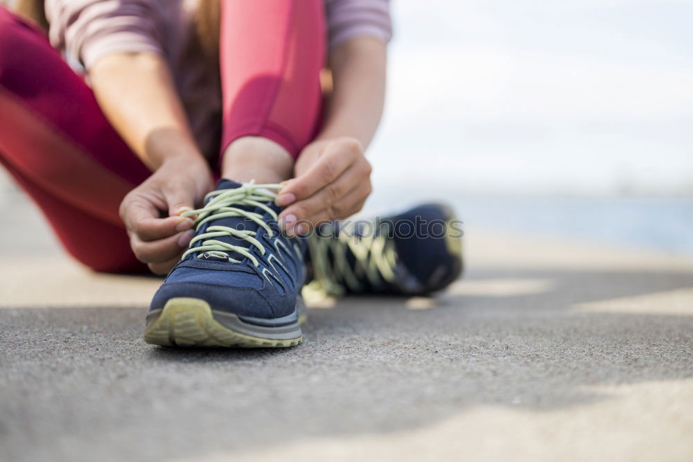 Similar – Runner get ready for run, tying sneakers shoelaces