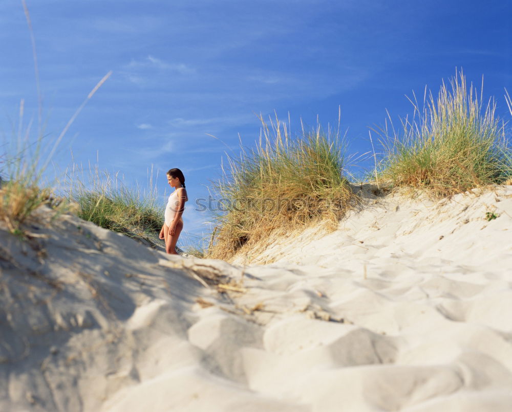 Similar – Young woman sitting alone on the beach and has wanderlust