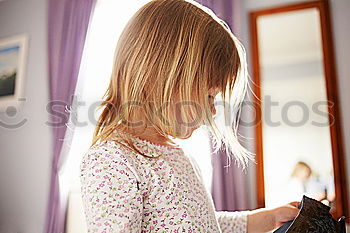 Similar – mother reading book to toddler daughter