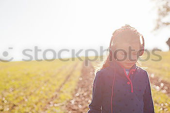 Similar – Little girl walking in nature field wearing beautiful dress