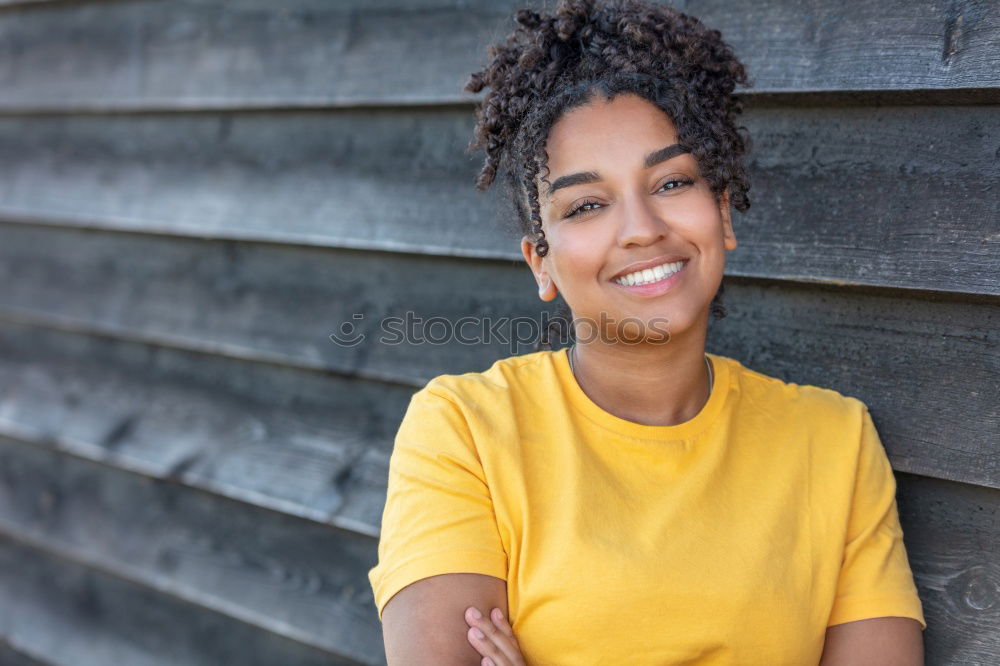 Similar – young african american woman in yellow dress enjoying a garden with yellow flowers