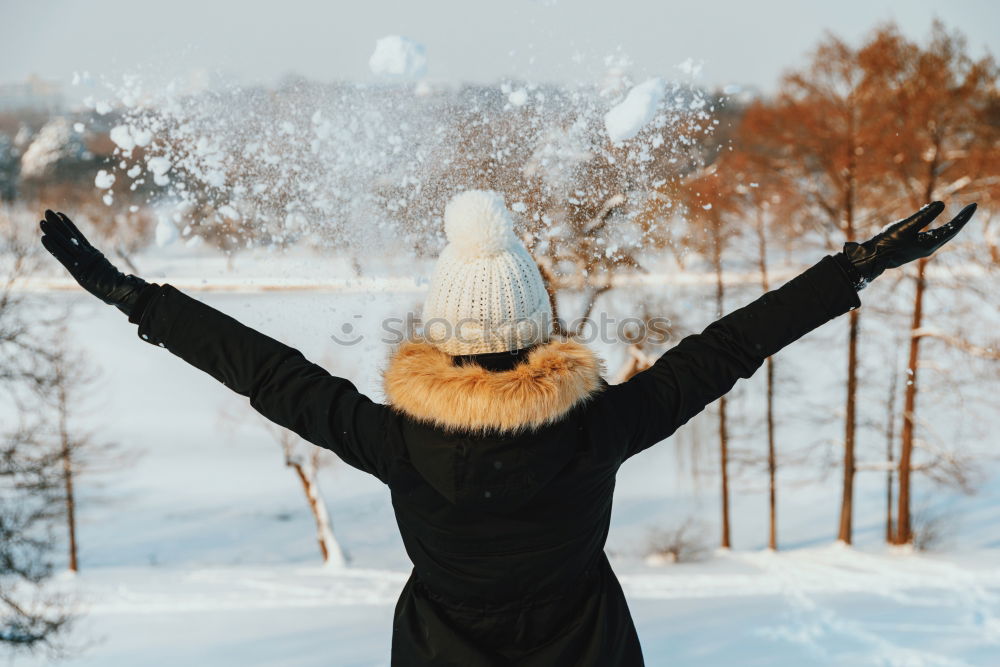 Similar – Woman walking outdoors on sunny snowy day in winter