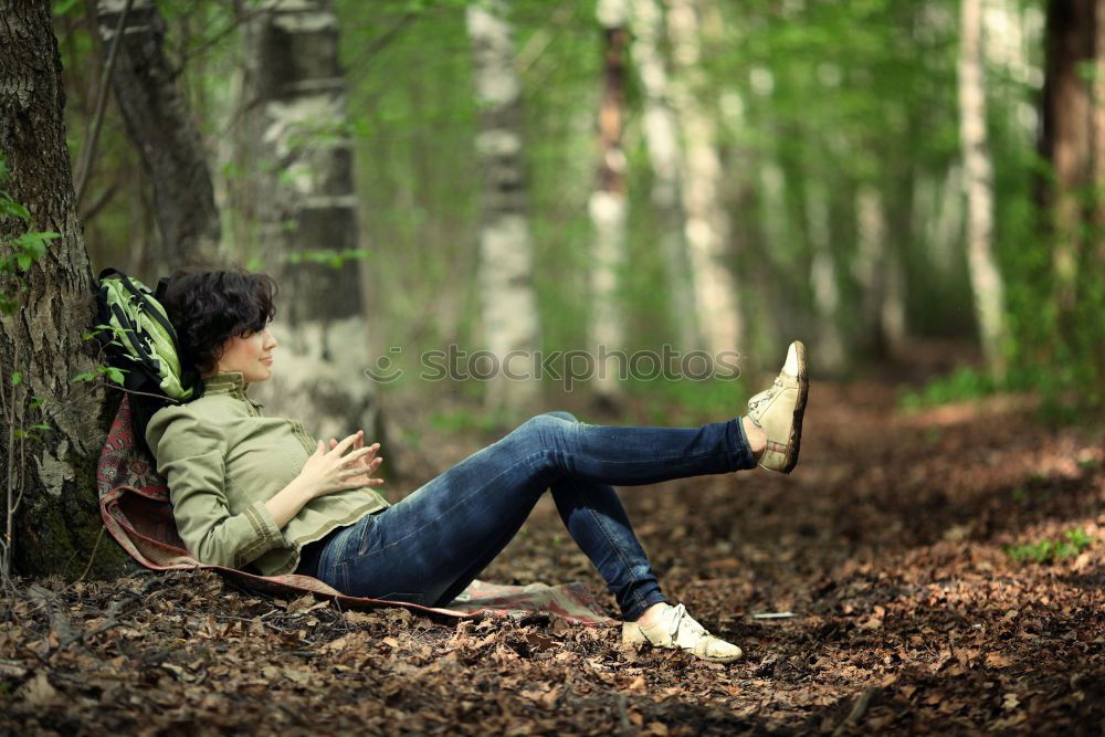 Similar – Woman relaxing on tree trunk