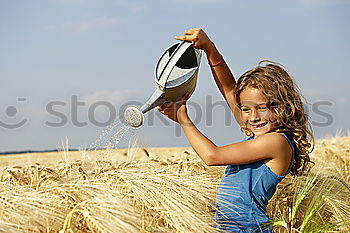 Similar – Image, Stock Photo smiling little girl holding wheat in hands