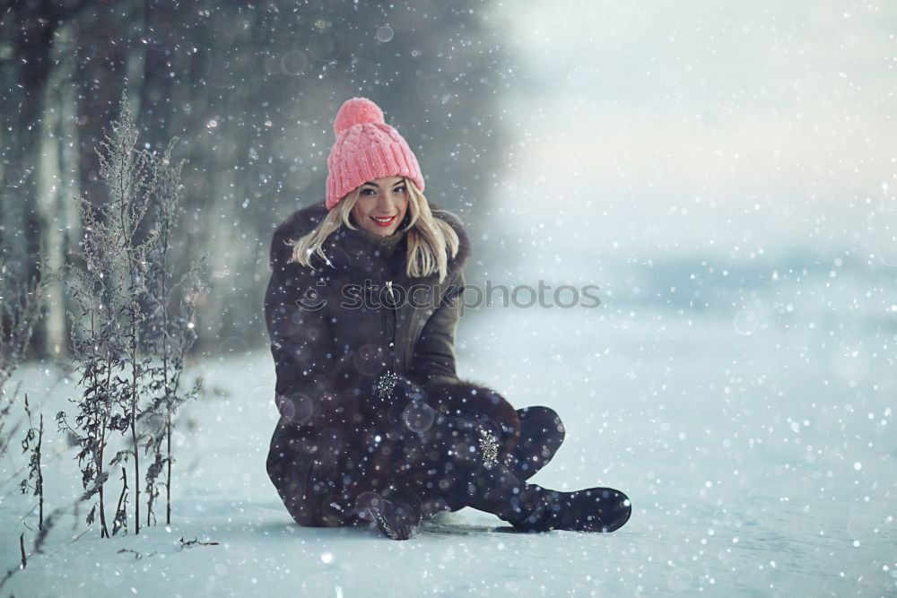 Young blonde woman lost in a snowy forest