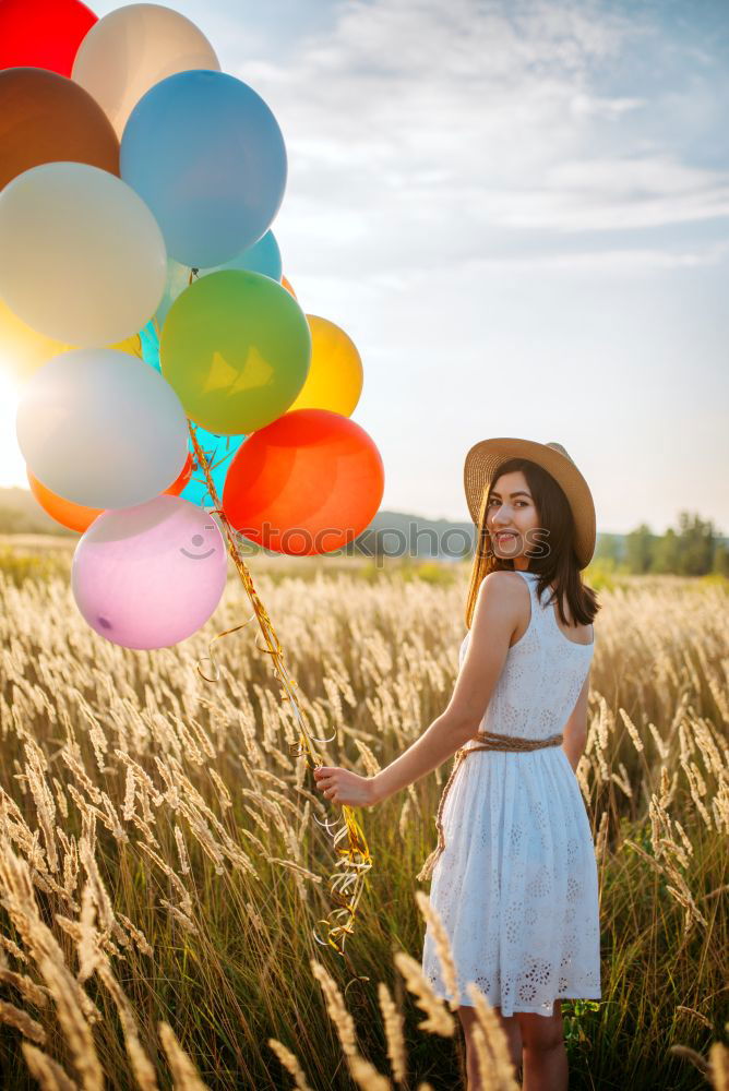 Similar – Image, Stock Photo Young woman with yellow dress and hat walks in the countryside.