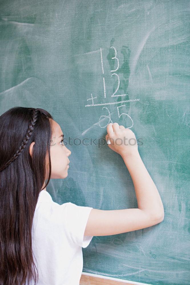 Similar – Pupil writing on the blackboard