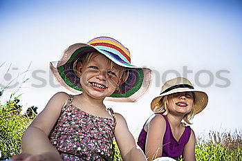 Similar – Image, Stock Photo Two happy children lie on a hammock and play with soap bubbles.