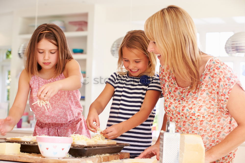 Similar – Little sisters girl preparing baking cookies.