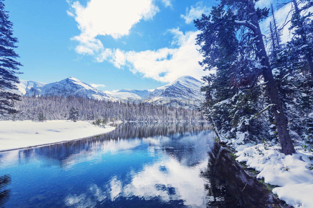 Similar – snowy mountain lake with mountains and blue sky