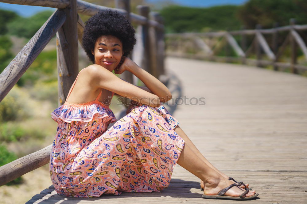 Image, Stock Photo Beautiful young black woman lying down in a  wooden foot bridge at the beach