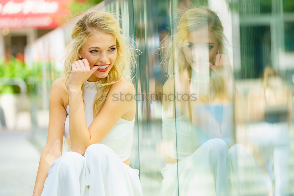 Similar – Image, Stock Photo Beautiful young blonde woman in urban background.