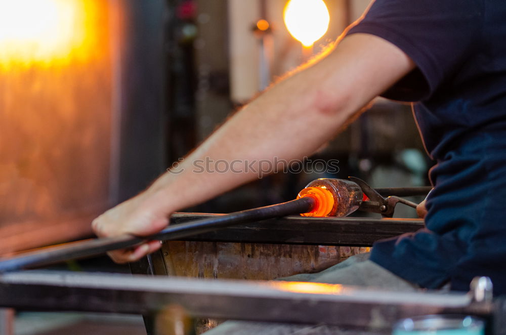 Similar – Unrecognizable worker cutting metal in garage