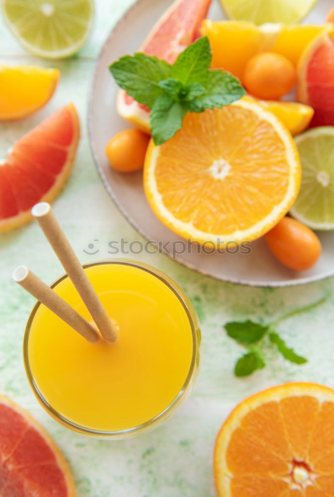 Similar – Glass of orange juice with slices of citrus fruit