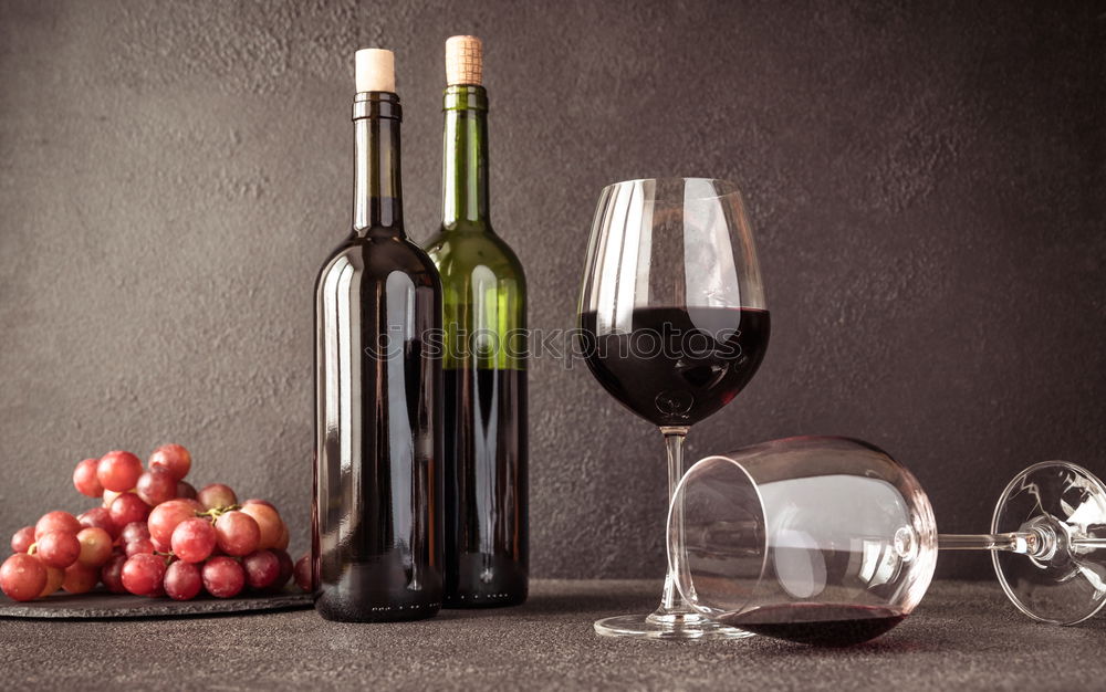 Similar – Red wine bottle and red wine glass with grapes