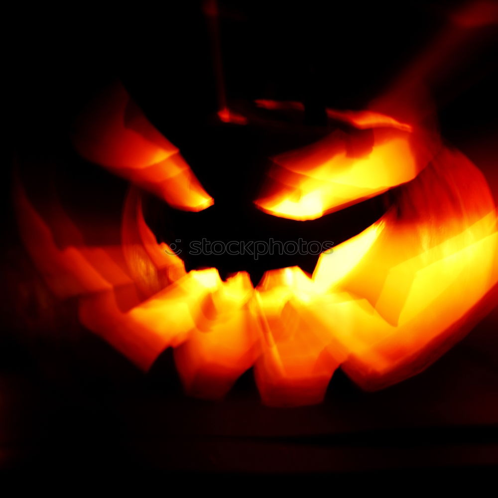 Similar – Creepy carved Halloween pumpkin burns in fire flames