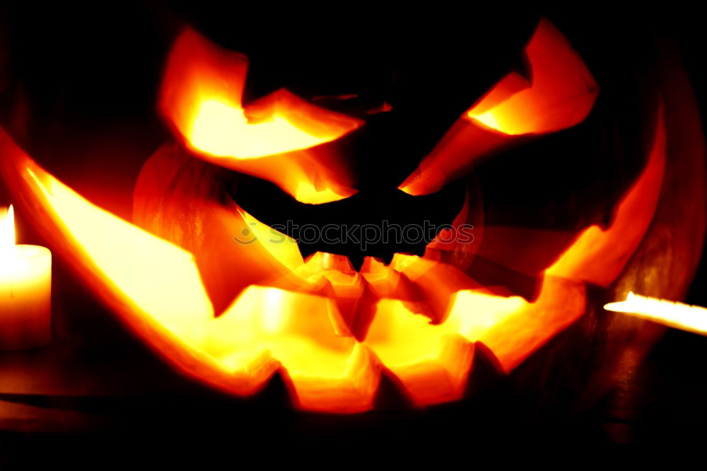 Similar – Creepy carved Halloween pumpkin burns in fire flames