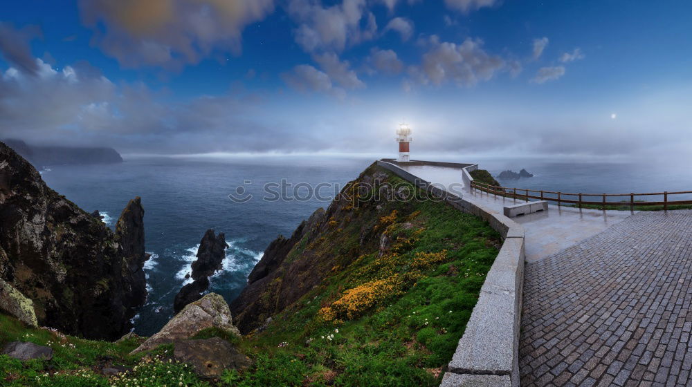 Similar – Felsenküste mit Leuchtturm in der Abenddämmerung