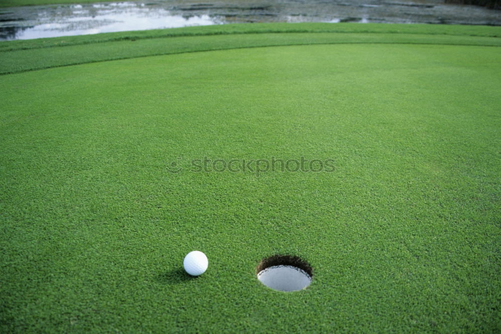 Similar – Minigolf ball holed on a minigolf course